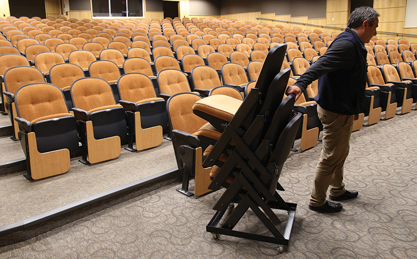 Moving Stacking Quattro chairs in auditorium