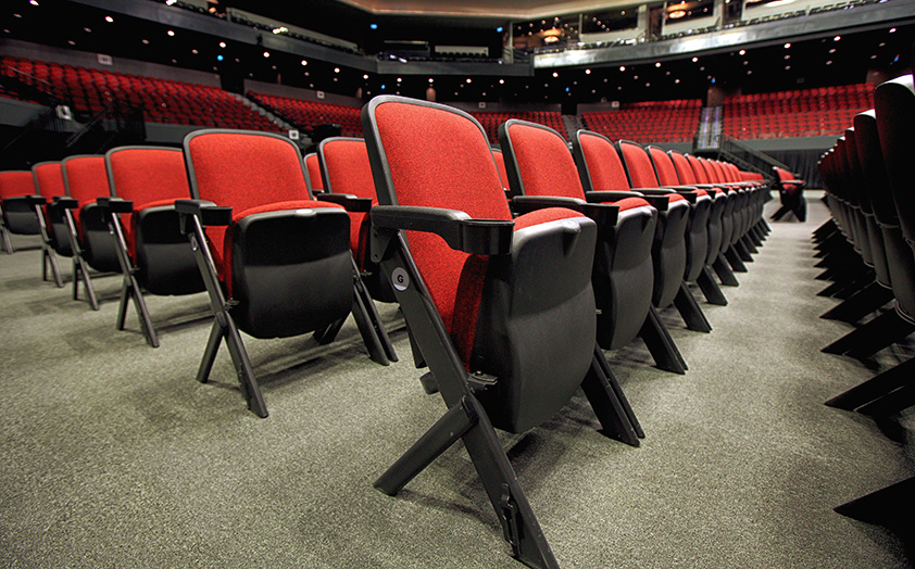 Stacking Quattro portable audience chairs with cupholders